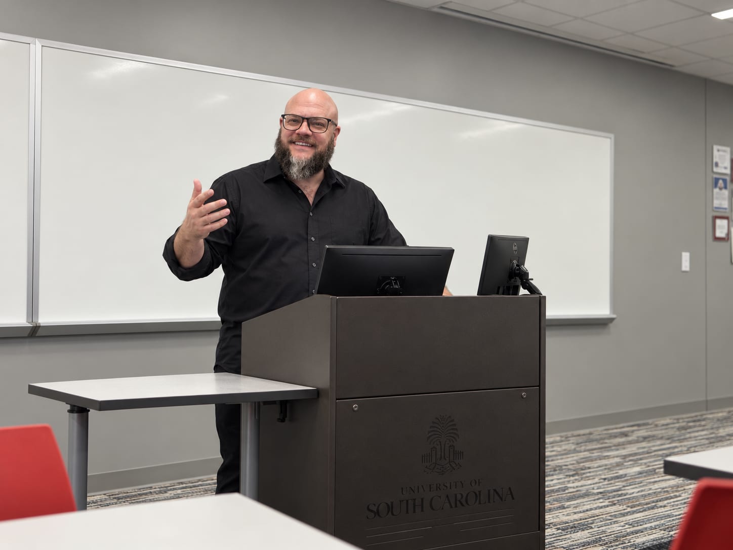 Mike T. Dial speaking at a podium at the University of South Carolina